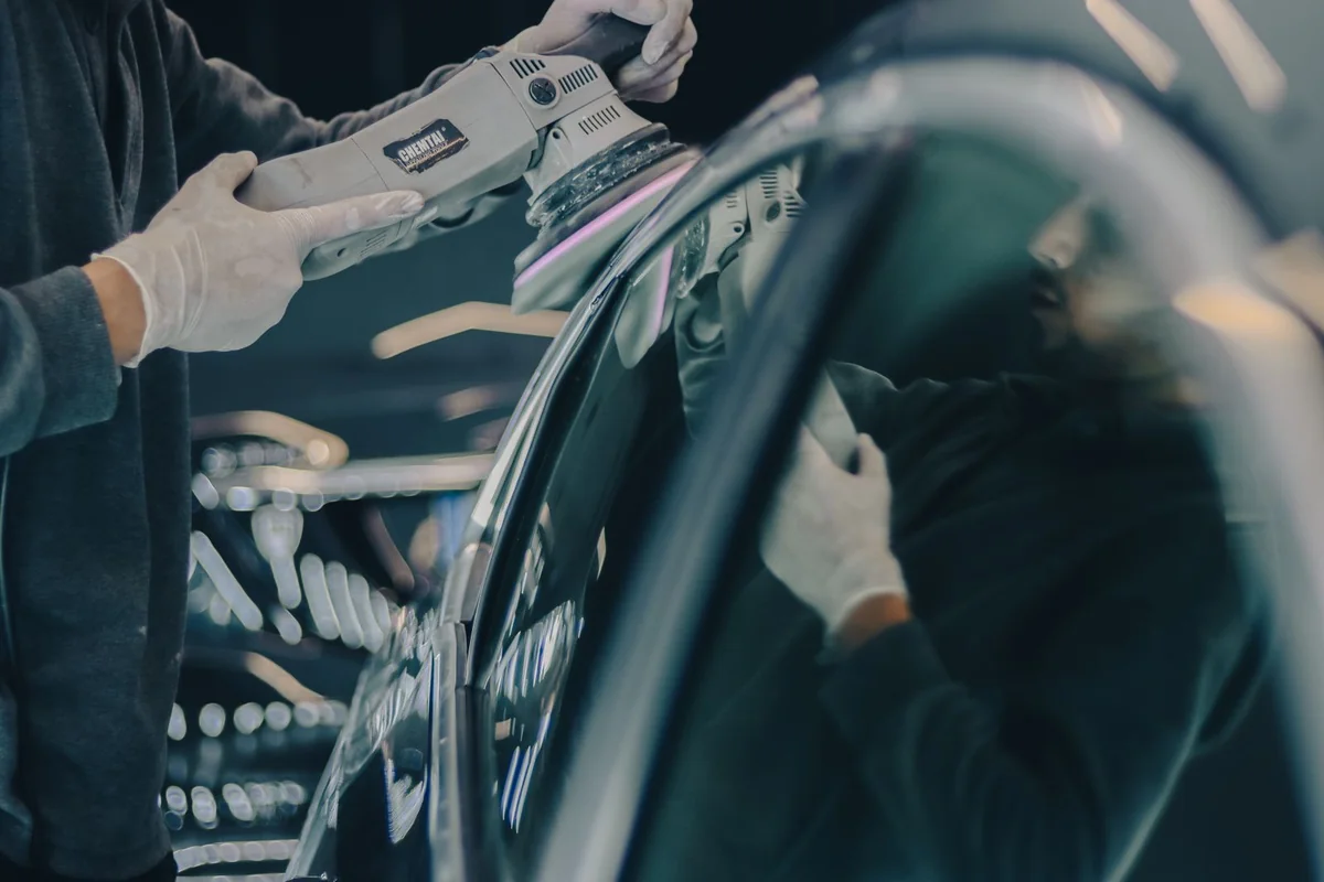Finishing work on a car body panel — illustrative service photograph
