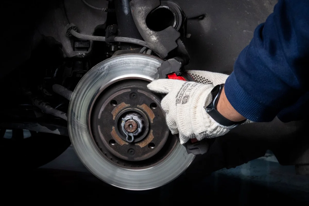 Brake disc inspection with the wheel removed — illustrative service photograph