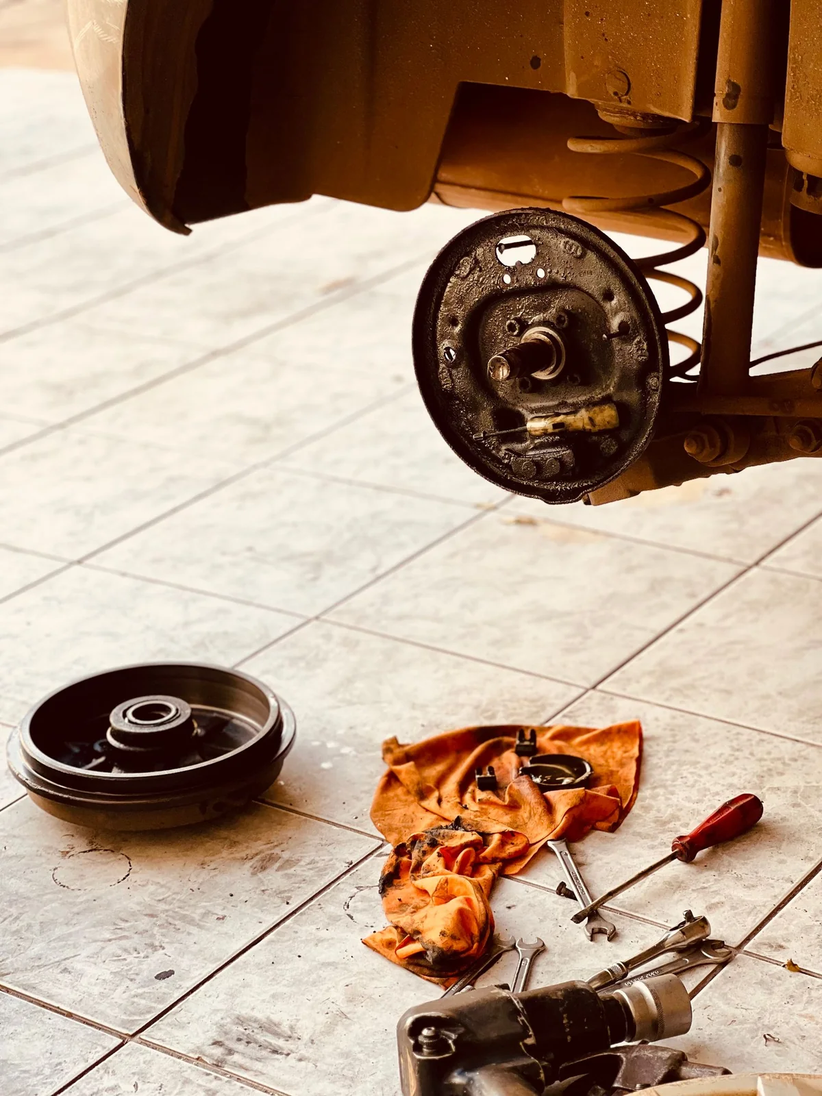 Rear suspension and wheel assembly during maintenance — illustrative service photograph